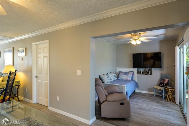 1303 Thompson St, North Fort Myers, FL 33903 - living room with ceiling fan, ornamental molding, wood finished floors, a textured ceiling, and baseboards