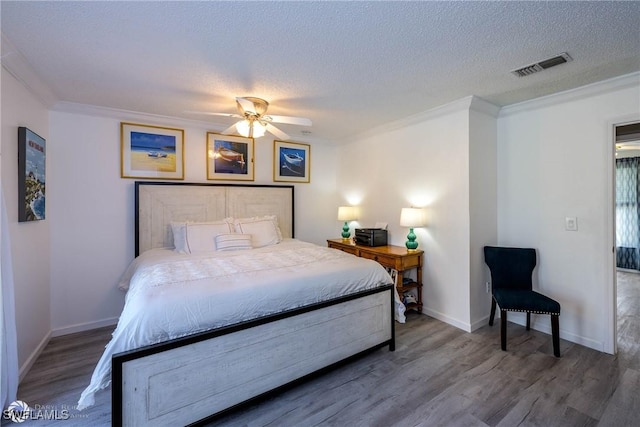 1303 Thompson St, North Fort Myers, FL 33903 - bedroom with ornamental molding, wood finished floors, a textured ceiling, baseboards, and a ceiling fan