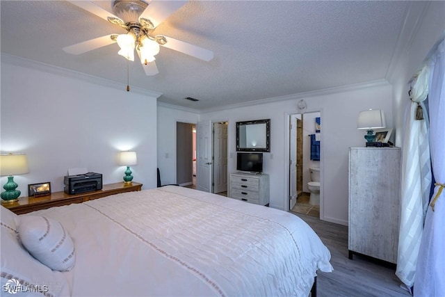 1303 Thompson St, North Fort Myers, FL 33903 - bedroom featuring crown molding, wood finished floors, ensuite bath, a textured ceiling, and a ceiling fan
