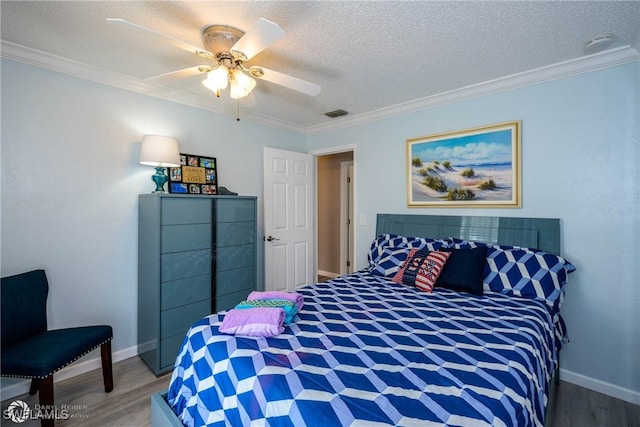 1303 Thompson St, North Fort Myers, FL 33903 - bedroom with light wood-style floors, crown molding, baseboards, a textured ceiling, and a ceiling fan