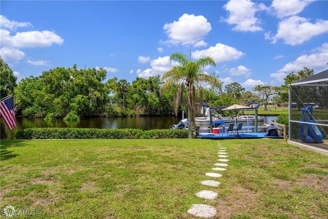 1303 Thompson St, North Fort Myers, FL 33903 - view of grassy yard with a water view and a boat dock