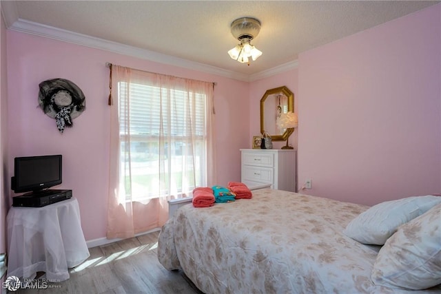 1303 Thompson St, North Fort Myers, FL 33903 - bedroom featuring wood finished floors, multiple windows, crown molding, and baseboards