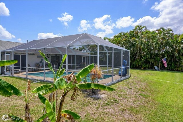 1303 Thompson St, North Fort Myers, FL 33903 - rear view of property featuring an outdoor pool and a lawn