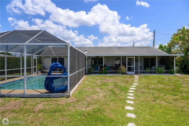 1303 Thompson St, North Fort Myers, FL 33903 - back of house featuring an outdoor pool, a lawn, and a lanai