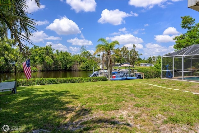 1303 Thompson St, North Fort Myers, FL 33903 - view of green lawn featuring a water view, glass enclosure, and an outdoor pool