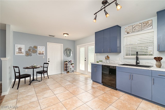 kitchen featuring dishwasher, a sink, blue cabinetry, and light countertops