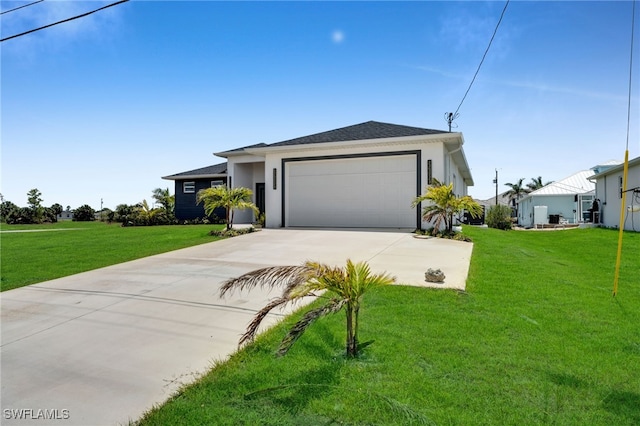 view of front of property with driveway, a garage, a front yard, and stucco siding