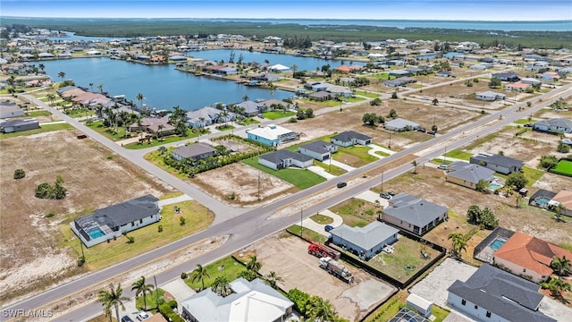 aerial view of residential area featuring a nearby body of water