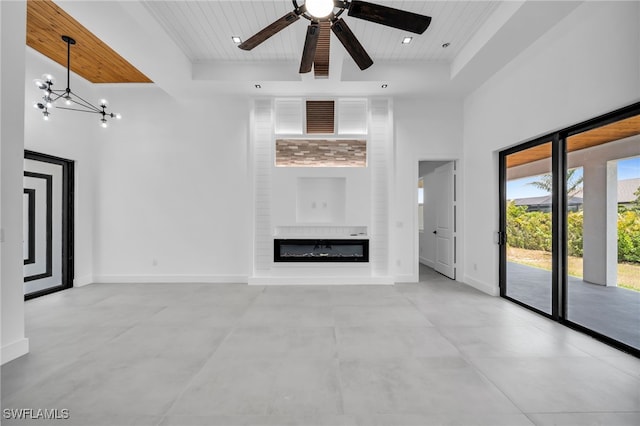 unfurnished living room featuring wood ceiling, a fireplace, baseboards, ceiling fan, and beam ceiling