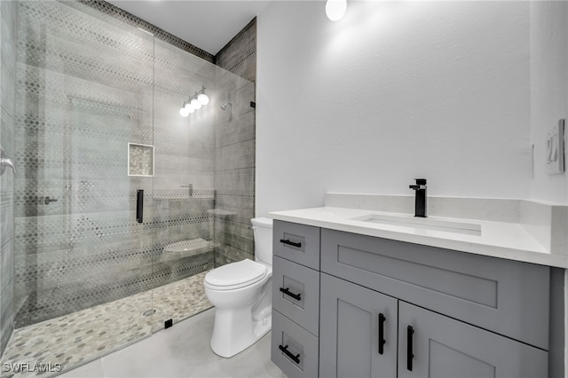 full bathroom with toilet, a shower stall, vanity, and tile patterned floors