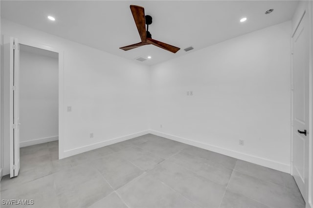 empty room featuring recessed lighting, baseboards, and light tile patterned flooring