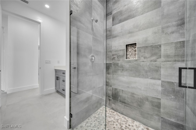 full bath with a stall shower, vanity, baseboards, and recessed lighting
