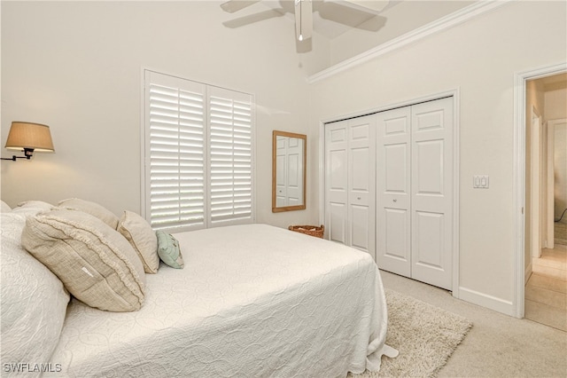 28839 Winthrop Cir, Bonita Springs, FL 34134 - bedroom with a closet, light carpet, a ceiling fan, baseboards, and a towering ceiling