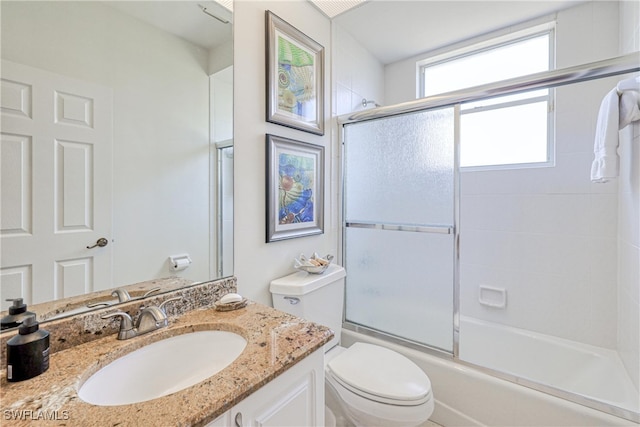 28839 Winthrop Cir, Bonita Springs, FL 34134 - bathroom featuring toilet, combined bath / shower with glass door, and vanity