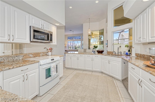 28839 Winthrop Cir, Bonita Springs, FL 34134 - kitchen featuring appliances with stainless steel finishes, a sink, light tile patterned flooring, white cabinets, and recessed lighting