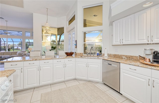 28839 Winthrop Cir, Bonita Springs, FL 34134 - kitchen featuring stainless steel dishwasher, a sink, a ceiling fan, light stone countertops, and light tile patterned floors