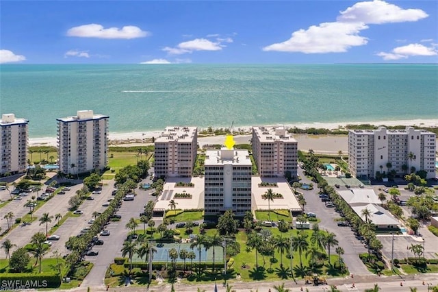 view of urban area featuring expansive beach and apartment complex