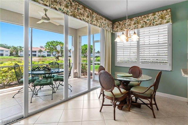 3045 Driftwood Way Unit 3707, Naples, FL 34109 - dining space featuring a chandelier, a ceiling fan, baseboards, tile patterned floors, and a residential view