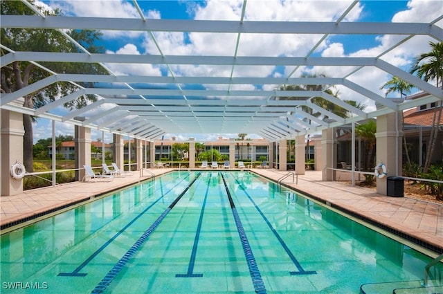 3045 Driftwood Way Unit 3707, Naples, FL 34109 - community pool featuring glass enclosure and a patio