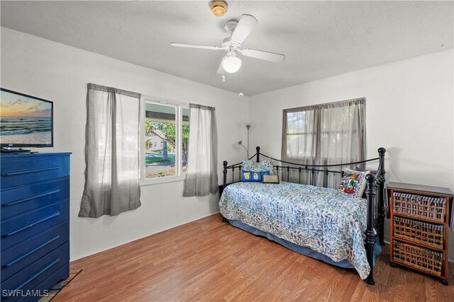 bedroom with wood finished floors and a ceiling fan