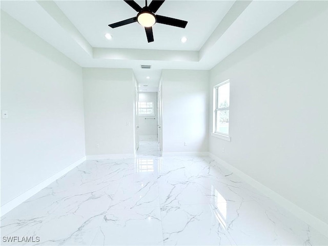 1312 Oak Ave, Lehigh Acres, FL 33972 - unfurnished room with ceiling fan, baseboards, marble tiled floors, recessed lighting, and a tray ceiling