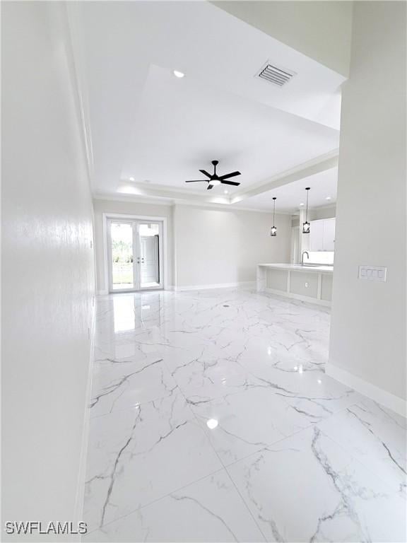 1312 Oak Ave, Lehigh Acres, FL 33972 - empty room featuring a raised ceiling, baseboards, ceiling fan, french doors, and marble finish flooring