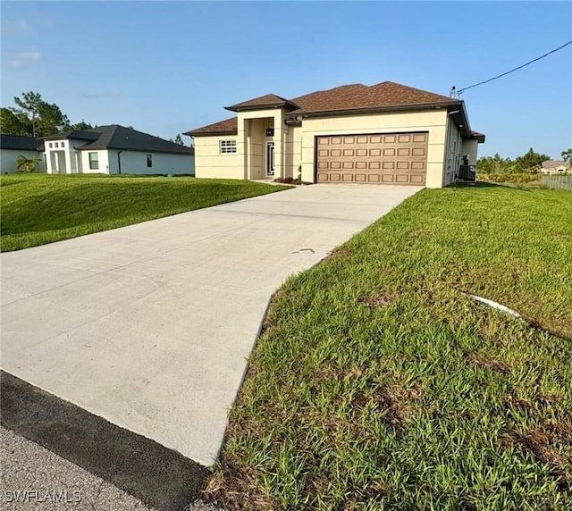1312 Oak Ave, Lehigh Acres, FL 33972 - view of front of home with an attached garage, concrete driveway, a front lawn, and stucco siding