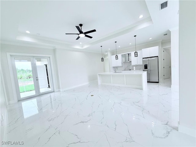 1312 Oak Ave, Lehigh Acres, FL 33972 - unfurnished living room featuring a tray ceiling, recessed lighting, baseboards, crown molding, and ceiling fan