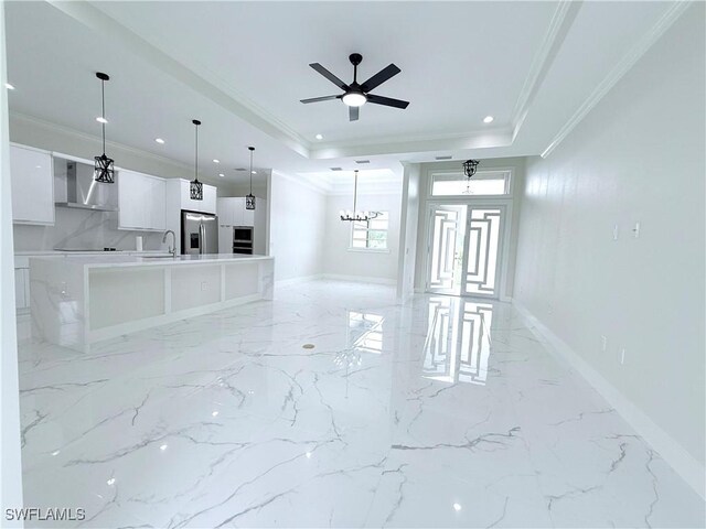 1312 Oak Ave, Lehigh Acres, FL 33972 - unfurnished living room featuring crown molding, a tray ceiling, recessed lighting, baseboards, and a sink