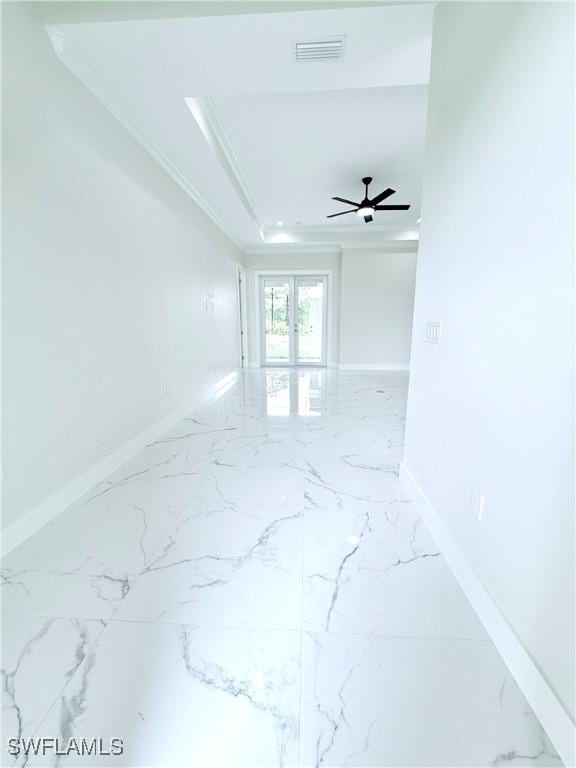 1312 Oak Ave, Lehigh Acres, FL 33972 - unfurnished room with marble tiled floors, baseboards, a tray ceiling, and ornamental molding