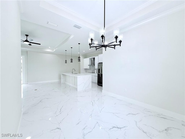 1312 Oak Ave, Lehigh Acres, FL 33972 - unfurnished living room featuring a tray ceiling, a sink, a chandelier, light marble finish floors, and baseboards