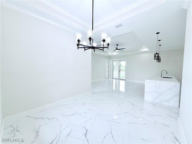 1312 Oak Ave, Lehigh Acres, FL 33972 - empty room with a raised ceiling, crown molding, a chandelier, marble finish floors, and baseboards