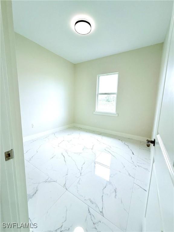 1312 Oak Ave, Lehigh Acres, FL 33972 - unfurnished room with marble finish floors and baseboards