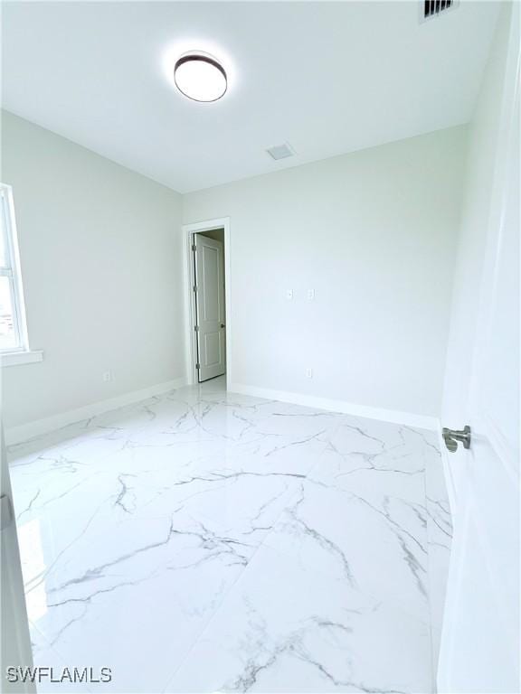1312 Oak Ave, Lehigh Acres, FL 33972 - empty room featuring marble finish flooring and baseboards