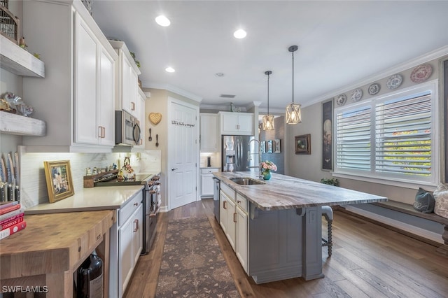 28268 Seasons Tide Ave, Bonita Springs, FL 34135 - kitchen with stainless steel appliances, ornamental molding, white cabinetry, backsplash, and dark wood-style floors