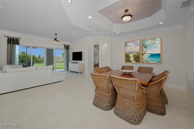 dining area featuring ornamental molding, ceiling fan, recessed lighting, baseboards, and a tray ceiling