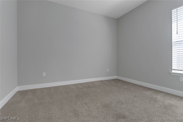 3307 Pilot Cir, Naples, FL 34120 - empty room featuring carpet flooring, baseboards, and vaulted ceiling
