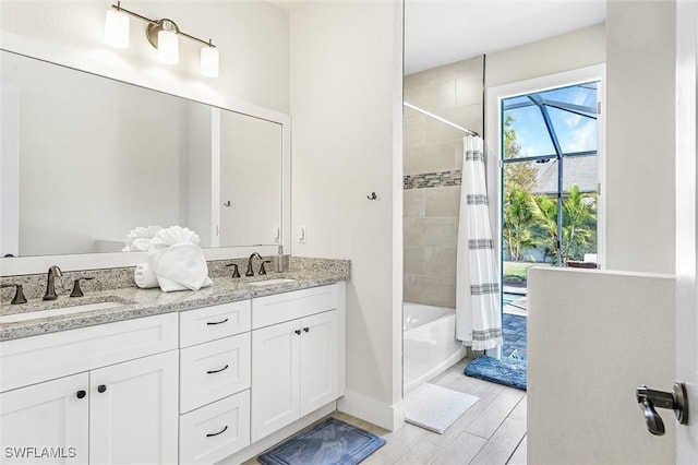 full bath with shower / bath combo, double vanity, and wood tiled floors