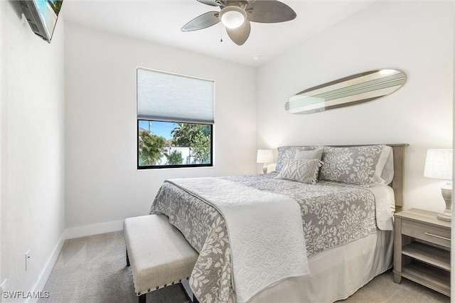 bedroom with light carpet, baseboards, and ceiling fan