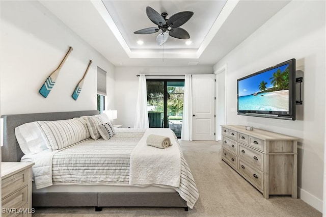 bedroom with access to outside, light carpet, a raised ceiling, a ceiling fan, and baseboards