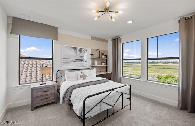20665 Napa Loop, Estero, FL 33928 - bedroom featuring baseboards, light carpet, and a chandelier