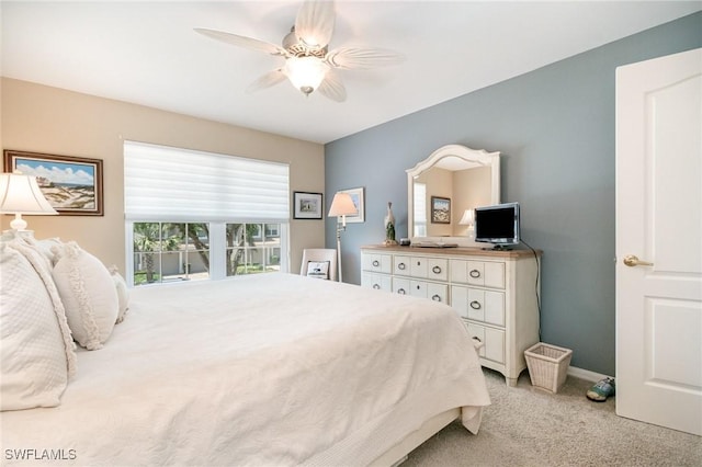 bedroom featuring light carpet, a ceiling fan, and baseboards