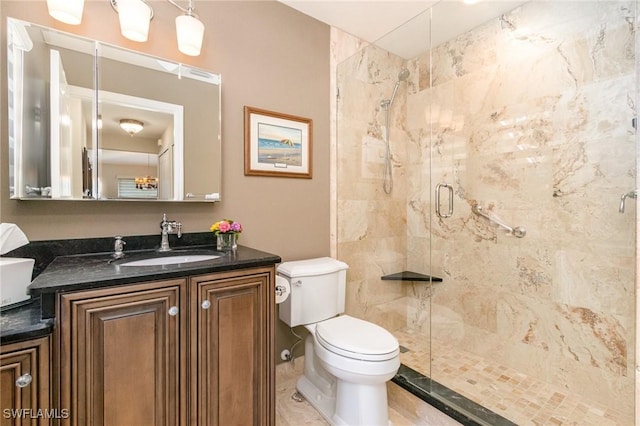 bathroom featuring toilet, a shower stall, and vanity