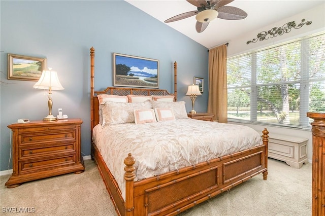 bedroom with light carpet, vaulted ceiling, ceiling fan, and baseboards
