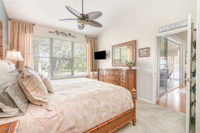 bedroom featuring light carpet, lofted ceiling, baseboards, and a ceiling fan