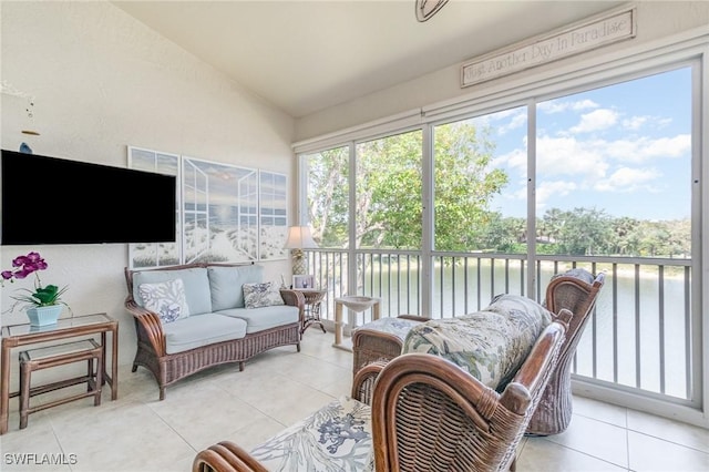 sunroom with a water view, lofted ceiling, and an outdoor living space