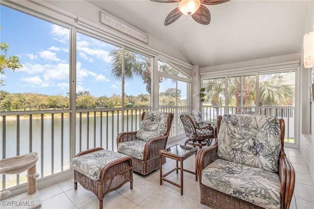 sunroom with a water view, a ceiling fan, and lofted ceiling