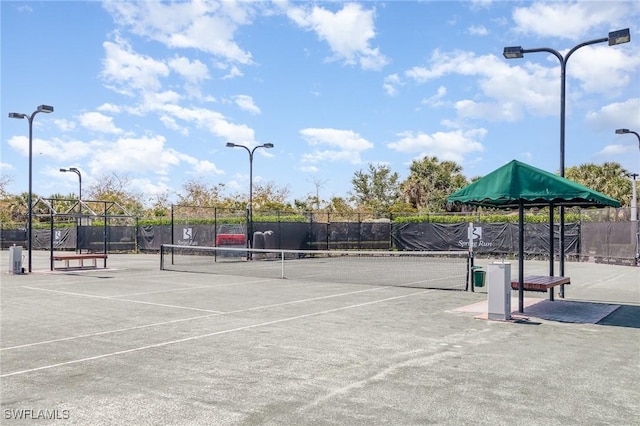 view of tennis court featuring fence