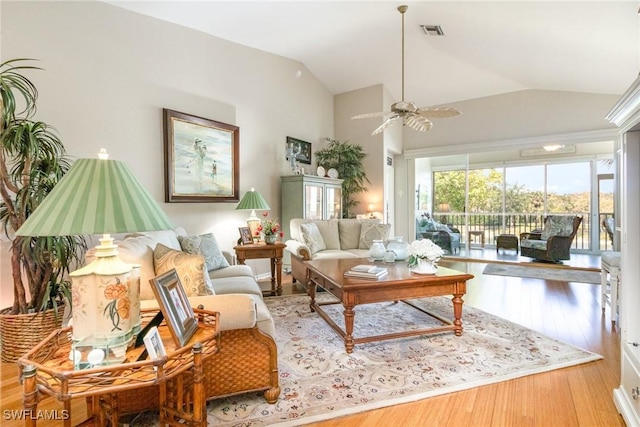living area with vaulted ceiling, wood finished floors, and ceiling fan