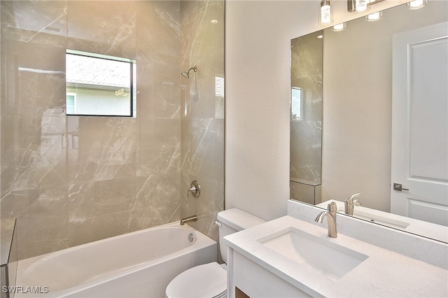 bathroom featuring toilet, tub / shower combination, and vanity